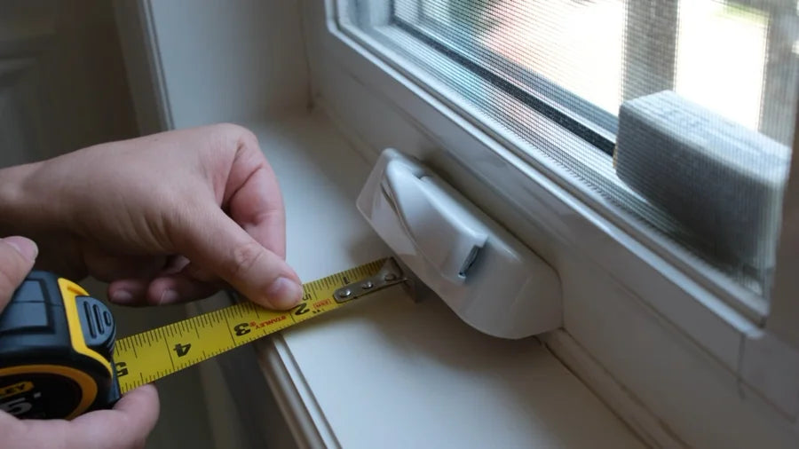 Hands checking clear recess depth behind a window handle with a tape measure